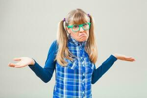 Portrait of a doubtful woman with green glasses photo