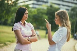 Business colleagues are arguing in park on break. photo