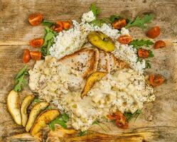 Tasty dish on a wooden board photo