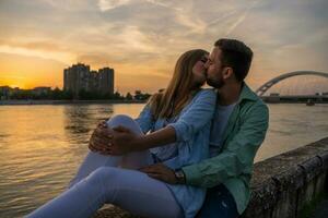 un joven Pareja terminado el puesta de sol foto