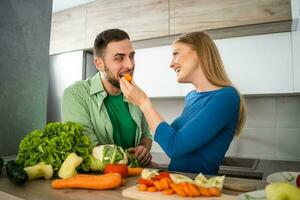 A young couple cooking together photo