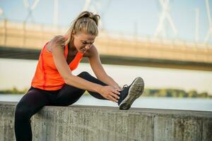 A woman in an orange t-shirt doing physical exercises photo