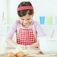 un joven niña Cocinando foto