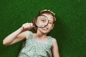 Little girl is lying on artificial grass photo