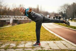 A senior man doing physical exercises photo