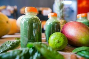 Healthy protein shake on table with fruits and vegetables ingredients around photo