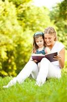 A mother and a daughter spending time outdoors photo