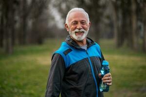 A senior man doing physical exercises photo