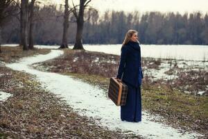 A woman with a travel bag photo