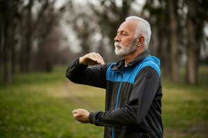 A senior man doing physical exercises photo