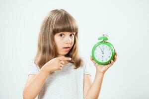 Portrait of a young girl with clock photo