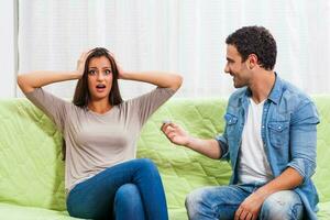 Portrait of a young couple arguing photo