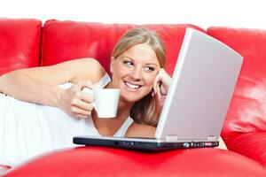 A woman with laptop on the couch photo