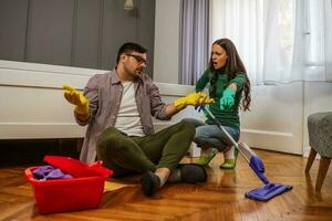 Young couple is cleaning their apartment photo