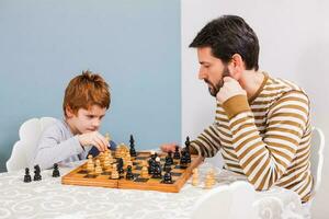 A man playing chess with a child photo