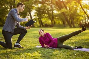 Couple exercising together in the park photo