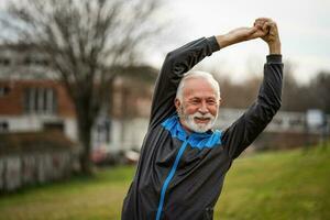 A senior man doing physical exercises photo