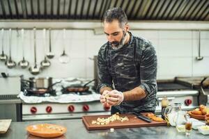 A chef is preparing a meal in the restaurant's kitchen. photo