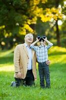 A grandfather and his grandson spending time together outdoors photo