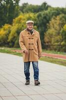 Outdoor portrait of a senior man walking in the park photo