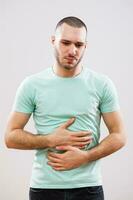 A man with green tshirt in pain photo