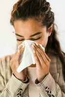 Portrait of a businesswoman blowing her nose photo