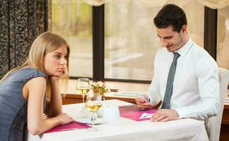 A couple having dinner at a restaurant photo