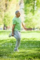 A senior man doing physical exercises photo