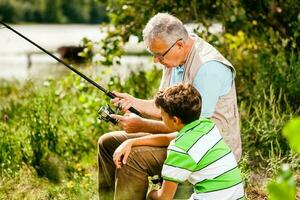 A grandfather and his nephew fishing photo