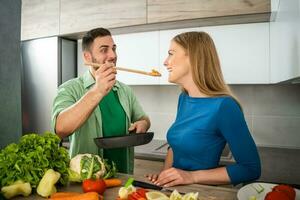 A young couple cooking together photo