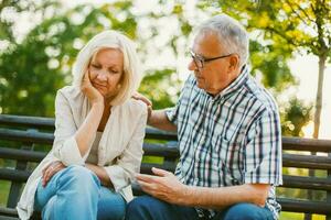 A senior couple spending time together in the park photo