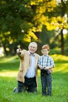 A grandfather and his grandson spending time together outdoors photo