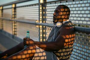 An African American man doing physical exercises photo