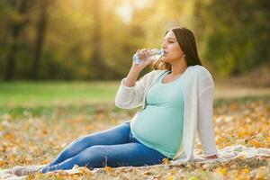 A pregnant woman spending time outdoors photo