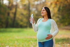 A pregnant woman spending time outdoors photo