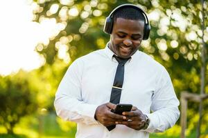 Afro businessman listening to music photo