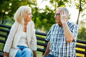 A senior couple spending time together in the park photo