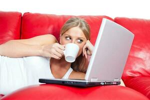 A woman with laptop on the couch photo