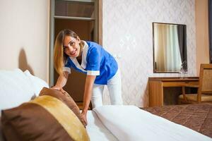 A maid working in a hotel room photo