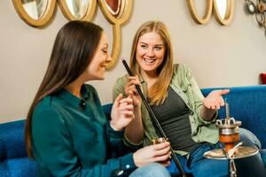 Friends spending time together and smoking hookah photo