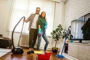 Young couple is cleaning their apartment photo