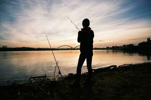 A boy is fishing on a sunny day photo