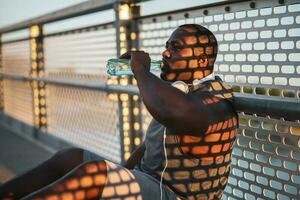 An African American man drinking water photo