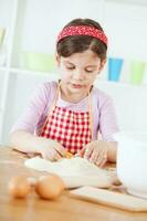 un joven niña Cocinando foto