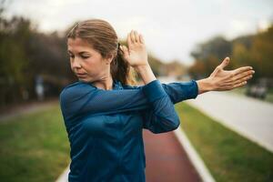 A young woman doing physical exercises photo