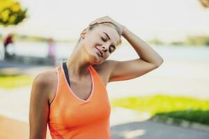 A woman in an orange t-shirt doing physical exercises photo