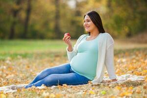 A pregnant woman spending time outdoors photo