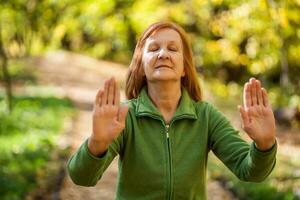 A senior woman doing physical exercises photo