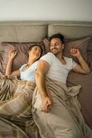 A young couple lying in bed photo