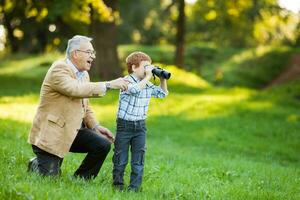 A grandfather and his grandson spending time together outdoors photo